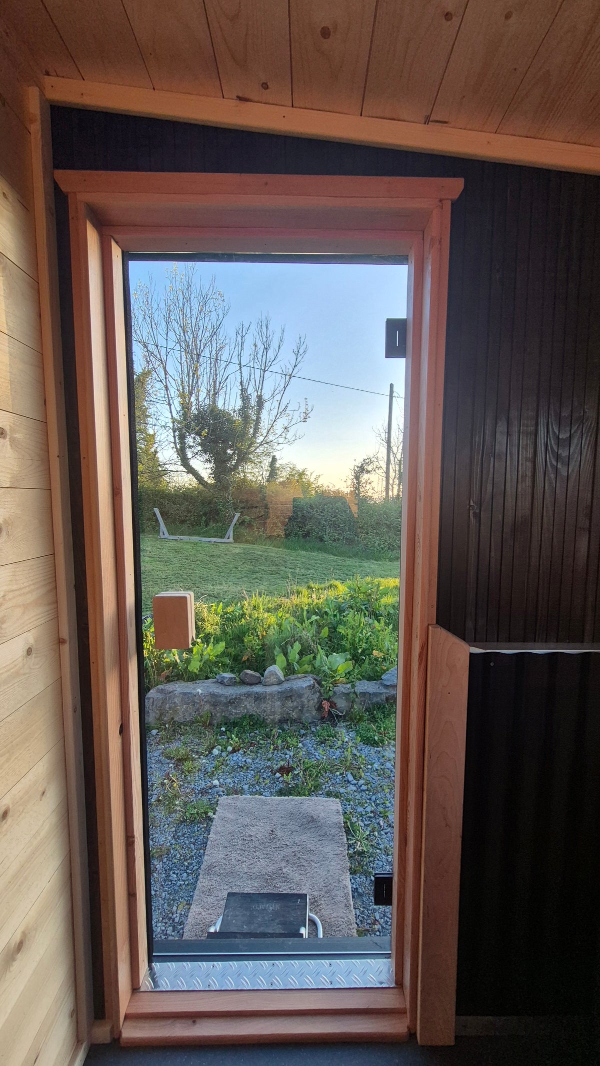 Secure glazed entrance door viewed from inside the Carra mobile sauna